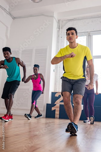 Low angle view of multicultural dancers practicing zumba in dance studio