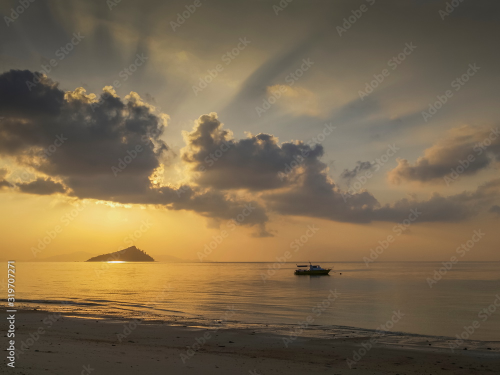 seaside of small boat floating in the sea with small island and sun