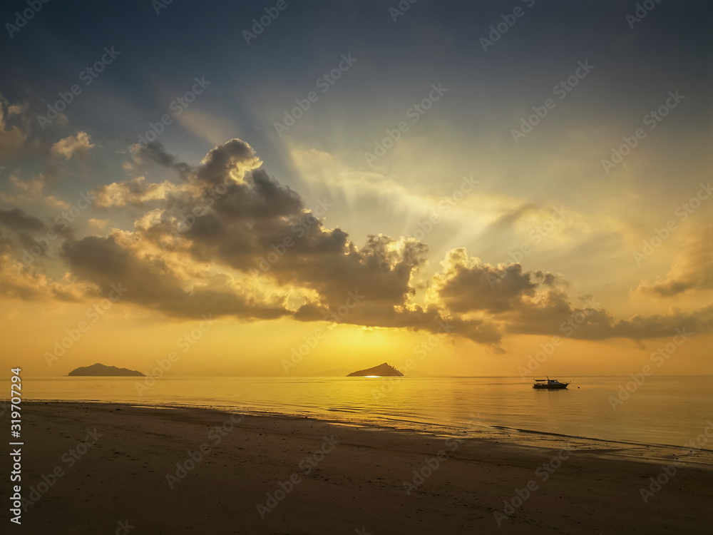 seaside of small boat floating in the sea with small island and sun
