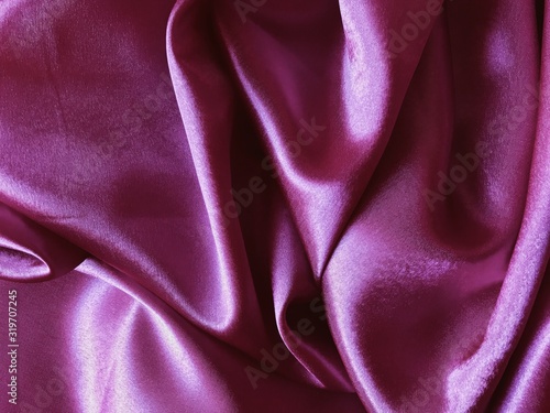Purple Silk satin fabric texture background, top view. fabric texture background. wavy canvas pattern. Fabric Tails