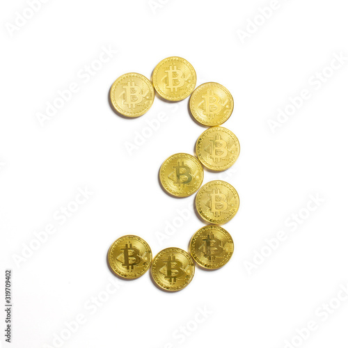 the figure of 3 laid out of bitcoin coins and isolated on white background
