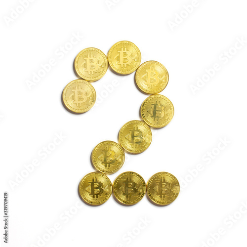 the figure of 2 laid out of bitcoin coins and isolated on white background