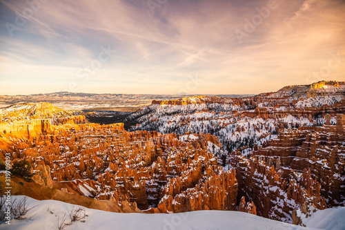 Panoramic view of a sunset on Bryce Canyon National Park in Winter covered with snow