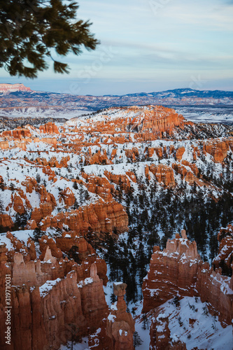 Night falling over Bryce Canyon National Park during winter covered with snow