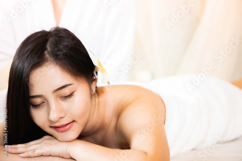 Asian Beautiful, young and healthy woman in spa salon. Massage treatment spa room . Traditional medicine and healing concept.