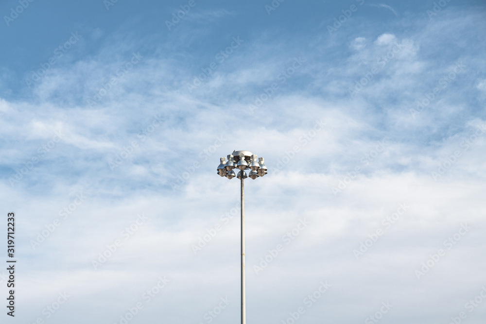 Streetlamp at day with blue sky in background