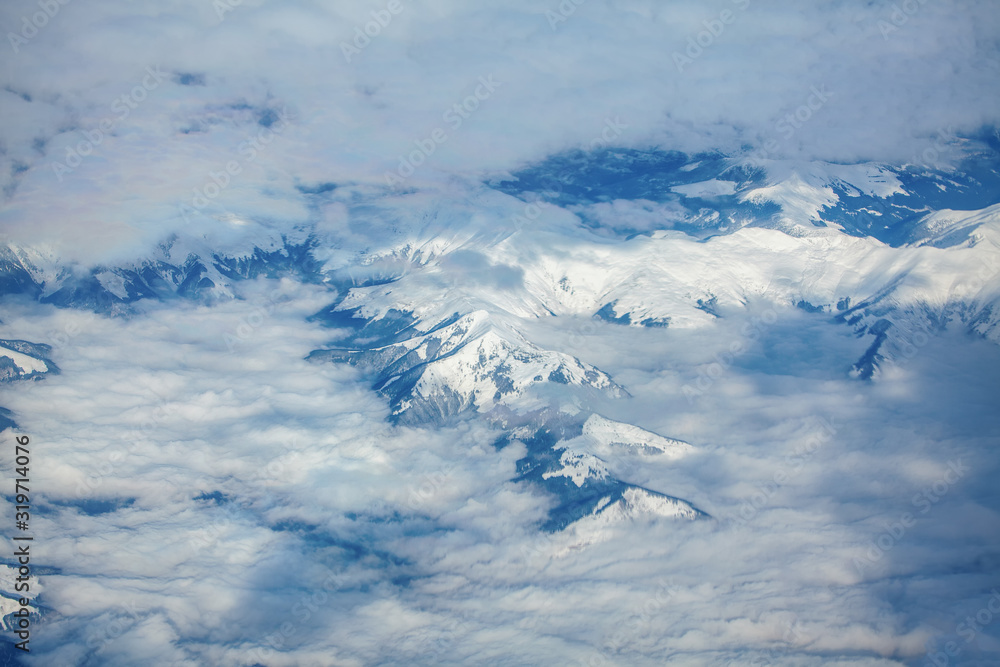 Fototapeta premium aerial view of clouds over the snowy mountains