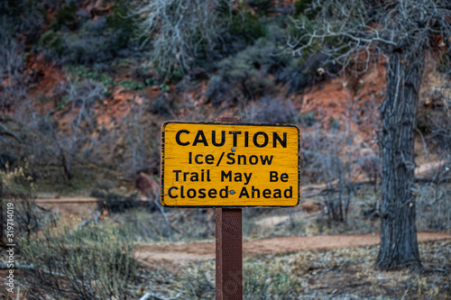 Caution "ice & snow" sign in Zion National Park during winter