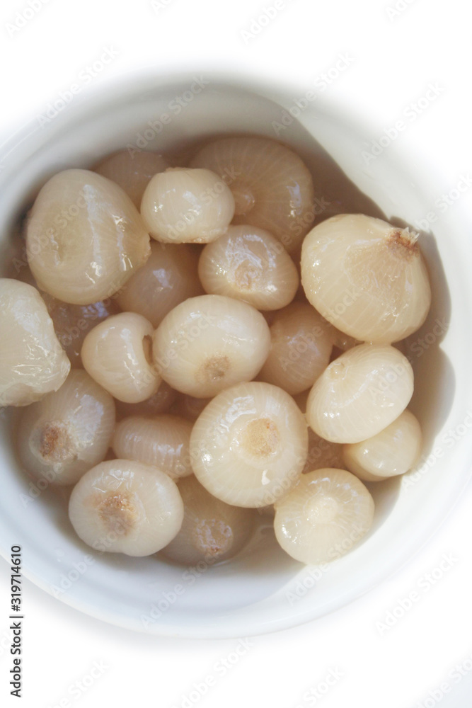 Pickled little pearl onions in a bowl isolated on white background Pickled little pearl onions in a bowl isolated on white background
