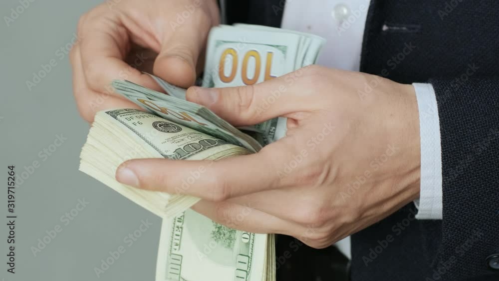 Men's hands quickly count banknotes. Businessman counts dollars in hands. USD