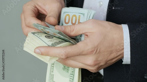 Men's hands quickly count banknotes. Businessman counts dollars in hands. USD