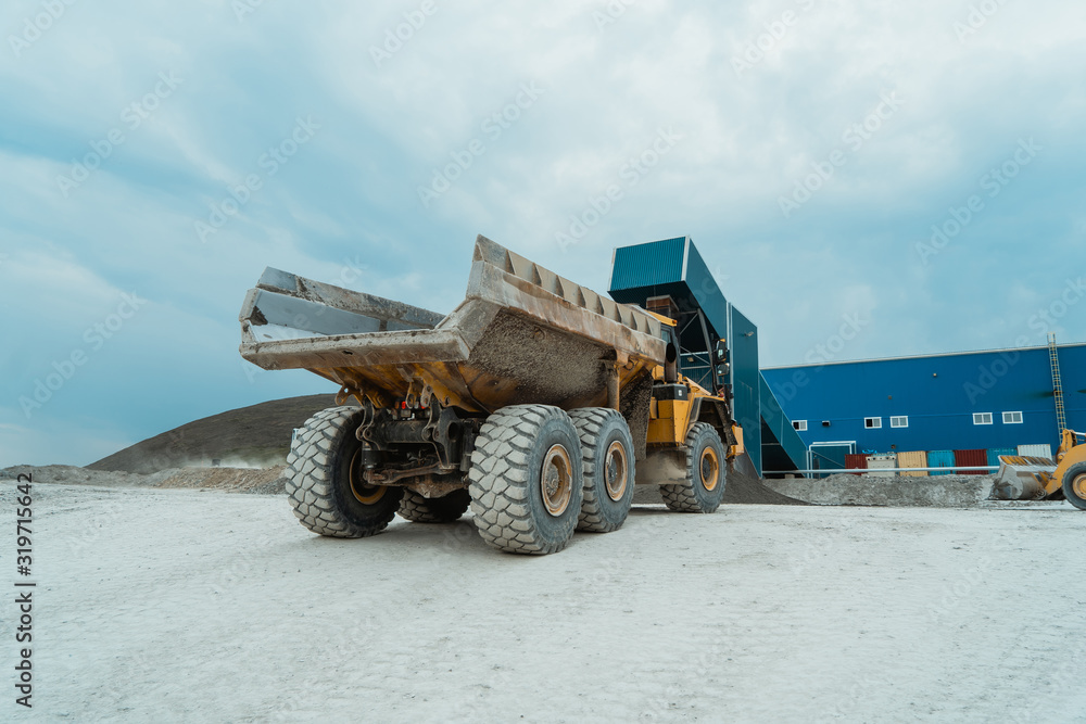 Obraz premium The mining dump truck stopped near the mill