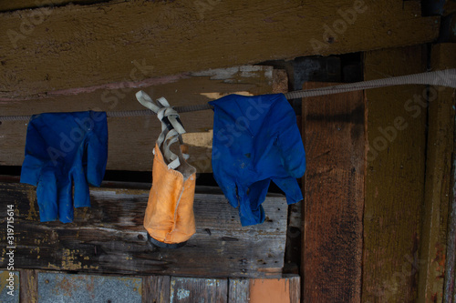 Mask and gloves hang on a rope in the old building of the affected area photo