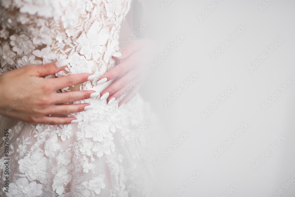 Luxury bride in white dress posing while preparing for the wedding ceremony Luxury bride in white dress posing while preparing for the wedding ceremony