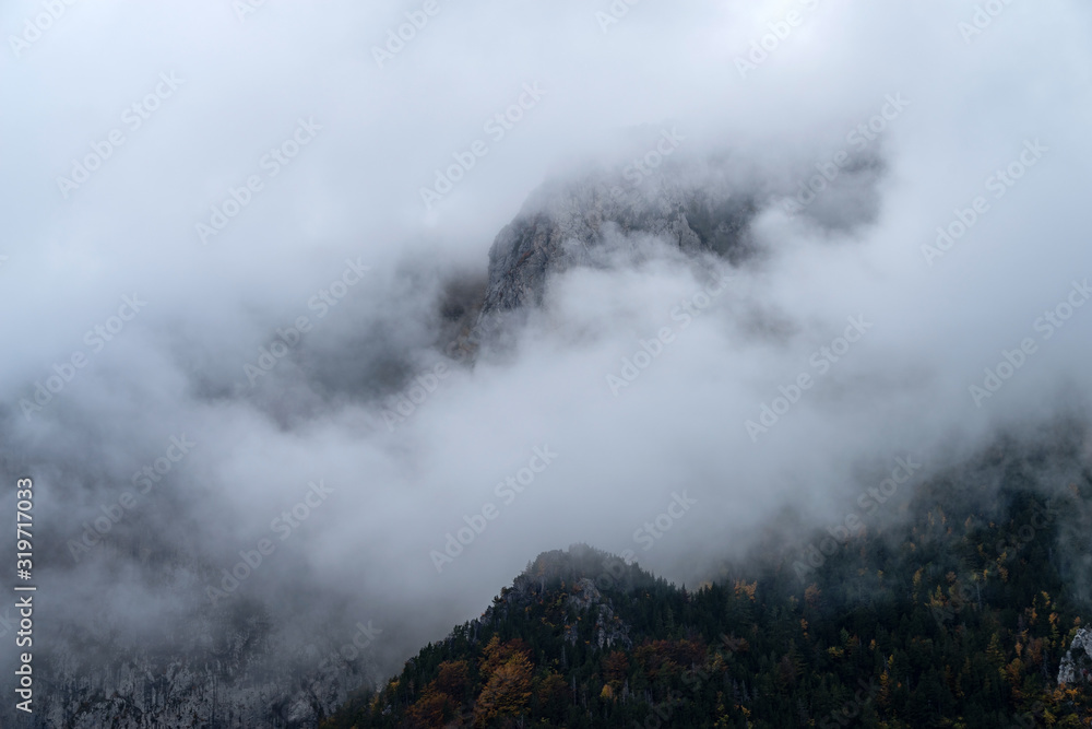 Fog revealing mountain, Italy