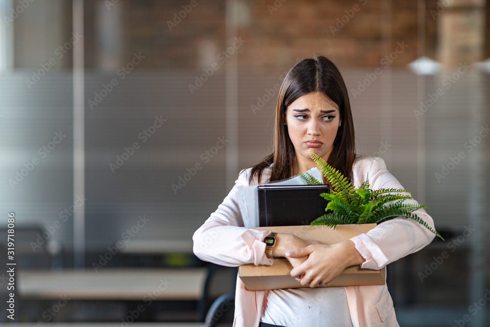 Close up view of new female employee intern holding cardboard box with belongings start finish job in company office, busnesswoman newcomer worker get hired fired on first last day at work concept Close up view of new female employee intern holding cardboard box with belongings start finish job in company office, busnesswoman newcomer worker get hired fired on first last day at work concept