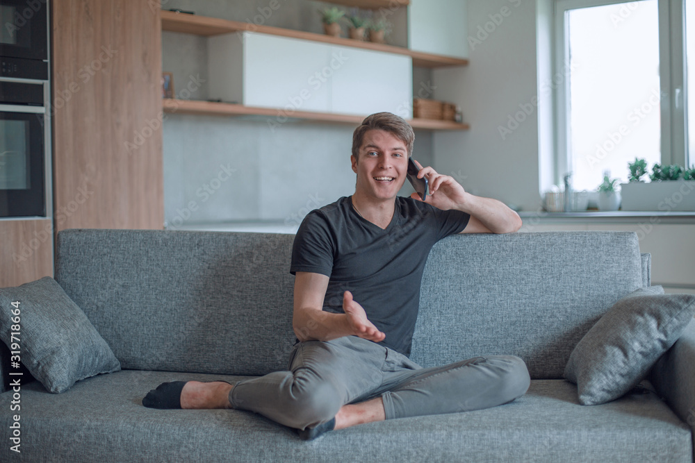 smiling young man talking on his smartphone smiling young man talking on his smartphone