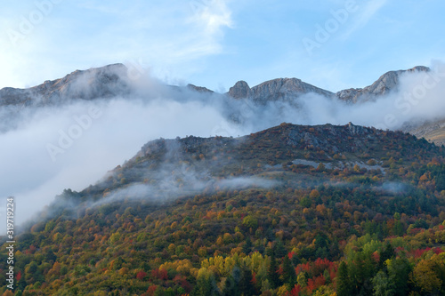 Fog revealing the Alpine mountain range, Italy
