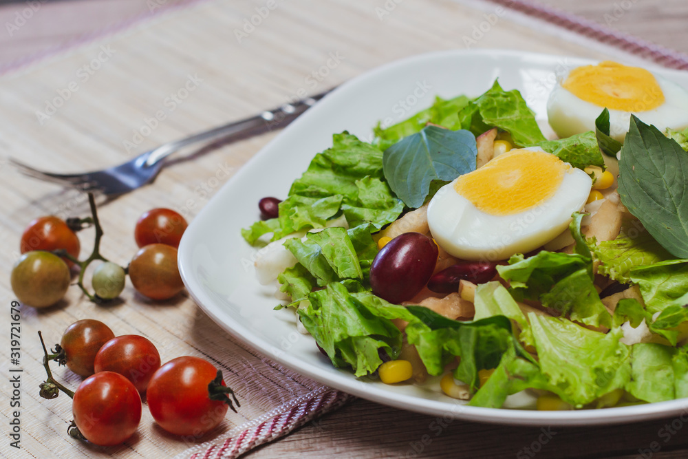 Vegetable salad, boiled eggs, tomatoes, tableware Vegetable salad, boiled eggs, tomatoes, tableware