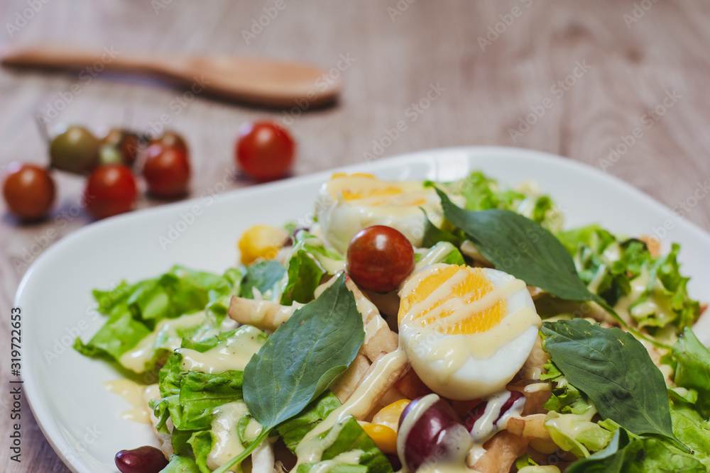 Vegetable salad, boiled eggs, tomatoes, tableware