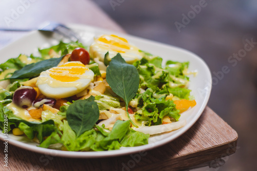 Vegetable salad, boiled eggs, tomatoes, tableware