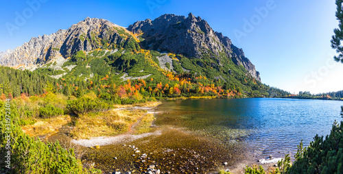 Fototapeta Naklejka Na Ścianę i Meble -  Panoramic picturesque view of mountain glacier lake Poprad (Slovak: Popradske pleso) in High Tatras, Slovakia. Sunny autumn day