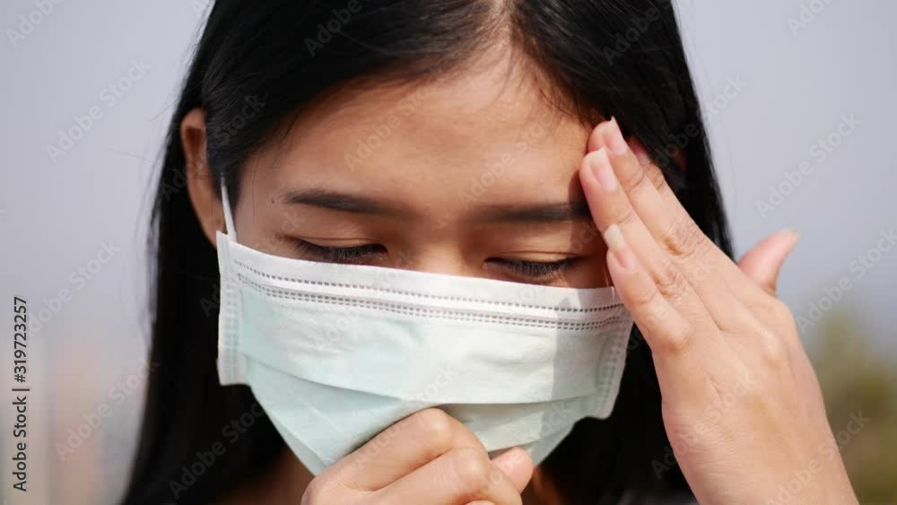 Asian women wearing dust mask and headache protect from wuhan coronavirus china health emergency. Asian women wearing dust mask and headache protect from wuhan coronavirus china health emergency.