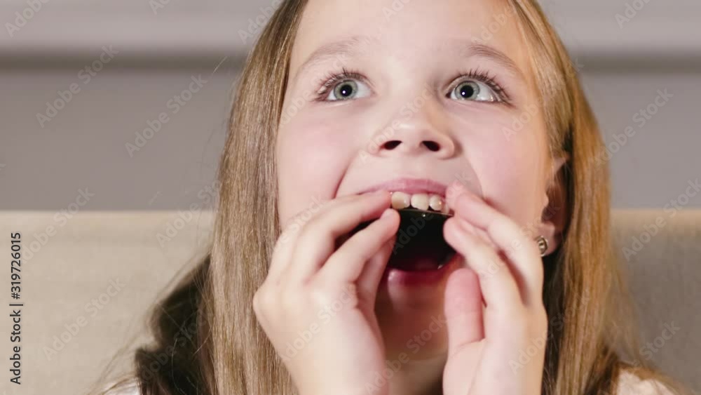 Pretty, kind girl inserts a stylish single-jawed orthodontic correction plate into her mouth. Alignment of teeth from a young age Pretty, kind girl inserts a stylish single-jawed orthodontic correction plate into her mouth. Alignment of teeth from a young age