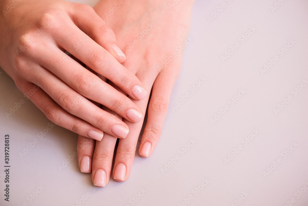 neat manicure hands on a neutral background neat manicure hands on a neutral background