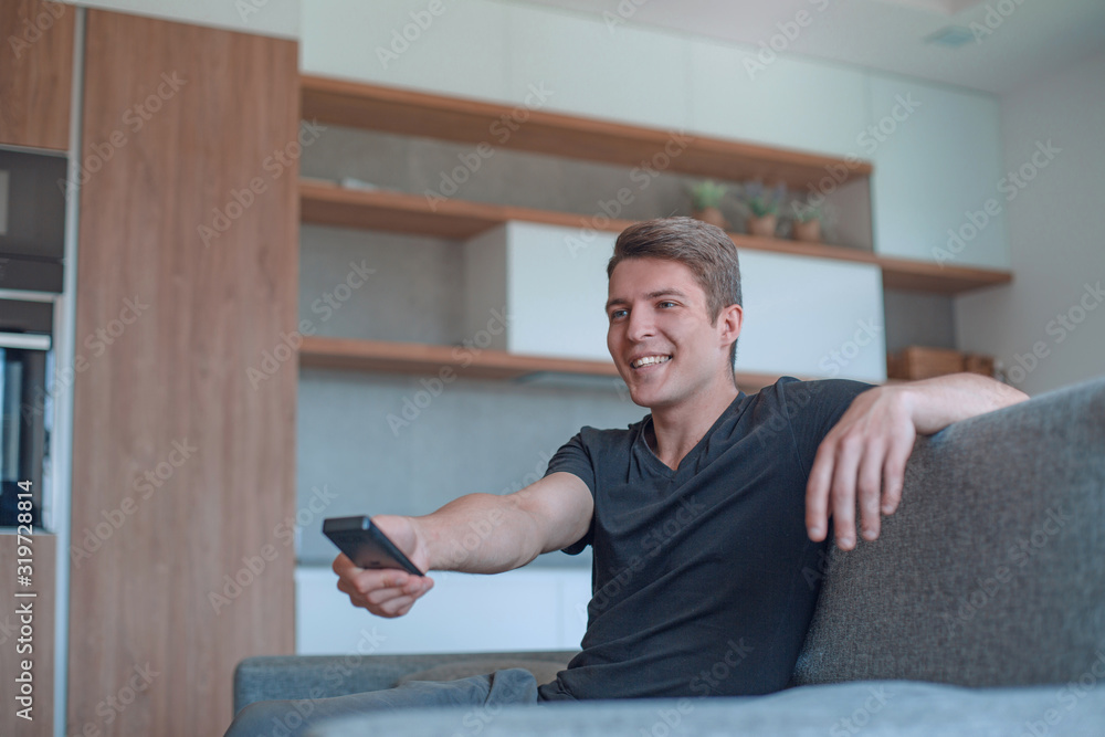 close up. young man using his smartphone to watch TV close up. young man using his smartphone to watch TV