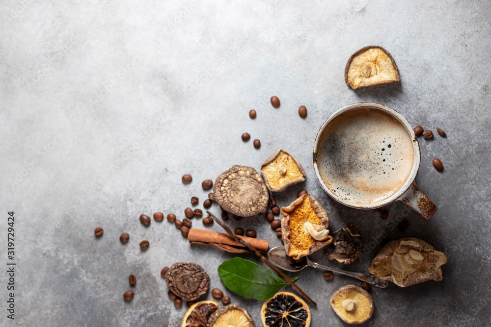 Mushroom coffee, a ceramic cup, mushrooms and coffee beans on stone concrete background. New Superfood Trend.