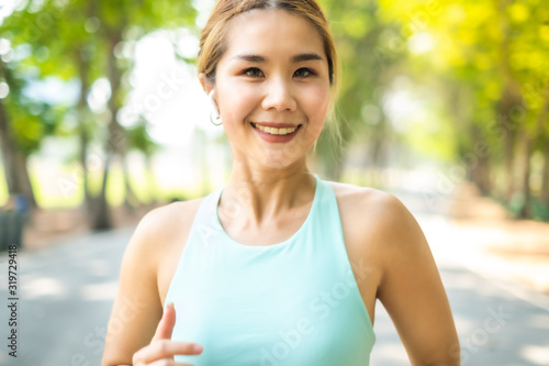 Running Asian woman. Female Runner Jogging during Outdoor Workout in a Park. Asian woman running in garden. Her morning exercise.