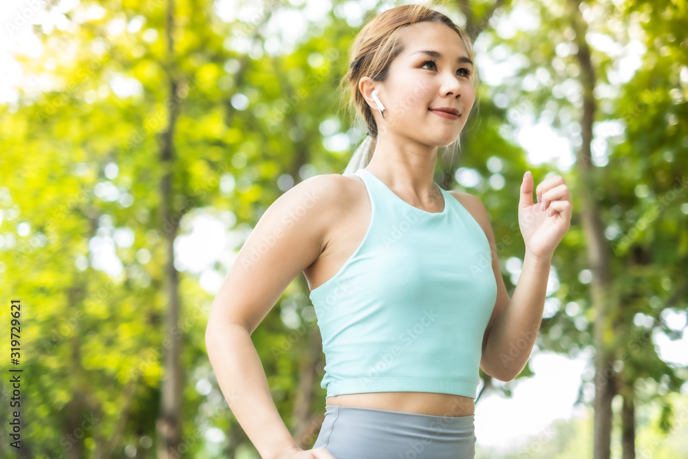 Running Asian woman. Female Runner Jogging during Outdoor Workout in a Park. Asian woman running in garden. Her morning exercise. Running Asian woman. Female Runner Jogging during Outdoor Workout in a Park. Asian woman running in garden. Her morning exercise.