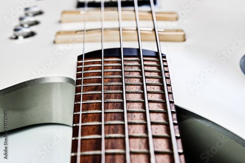 White bass guitar details on a white background with copy space