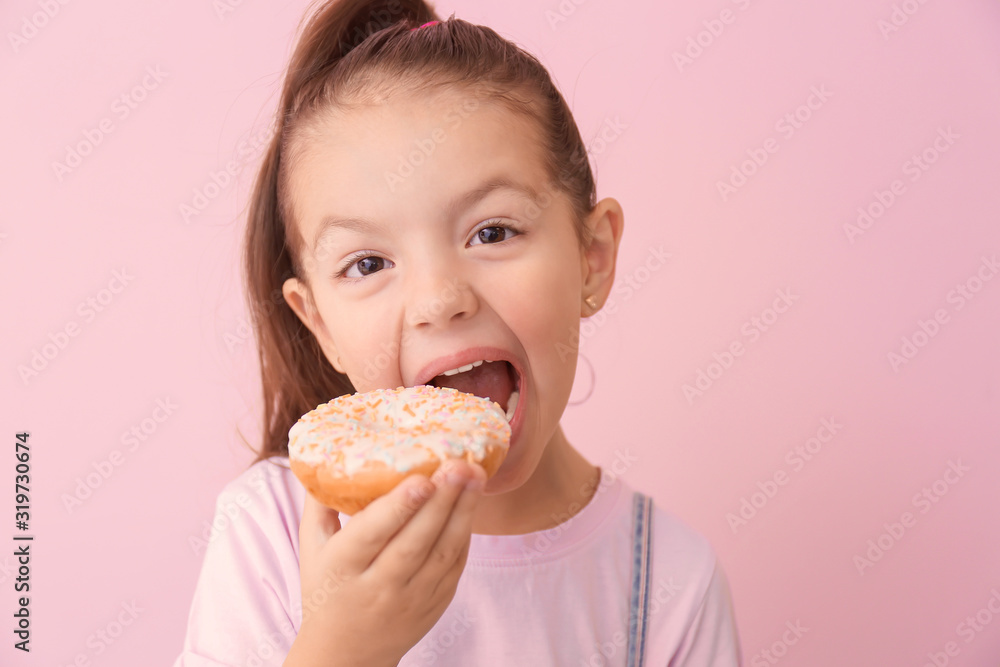 Funny little girl with donut on color background Funny little girl with donut on color background