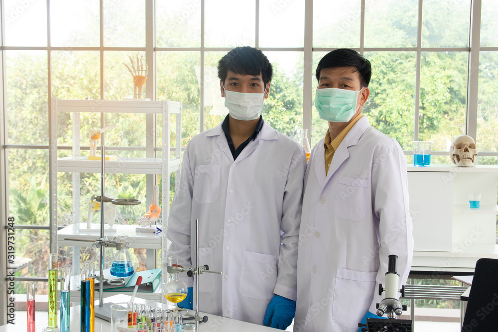Scientists or doctors are testing bloods to prevent and destroy new strains of the virus through tube and beaker. Researching and experimenting for effective chemicals. Successful teamwork concept. Scientists or doctors are testing bloods to prevent and destroy new strains of the virus through tube and beaker. Researching and experimenting for effective chemicals. Successful teamwork concept.