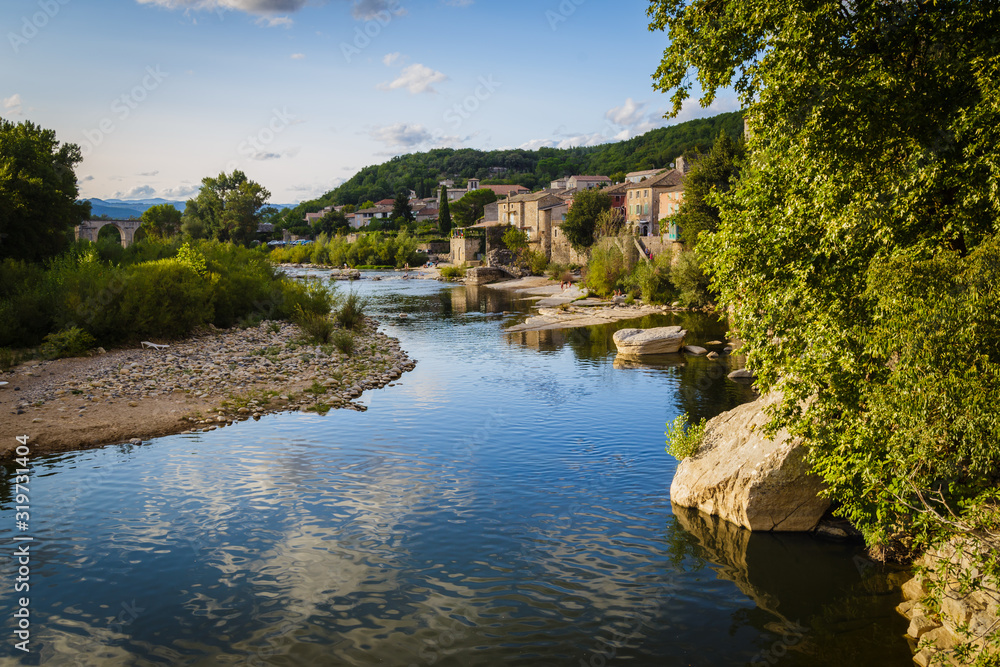 Ardeche river and old village of Vogüé at sunset