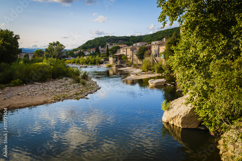 Ardeche river and old village of Vog     at sunset