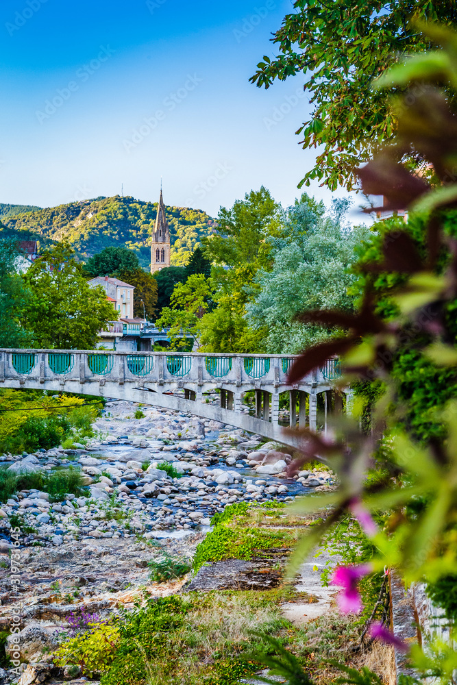 Bridge over la Volane river in Vals-les-Bains, a spa town in the Ardèche departement in southern France a day of summer Bridge over la Volane river in Vals-les-Bains, a spa town in the Ardèche departement in southern France a day of summer
