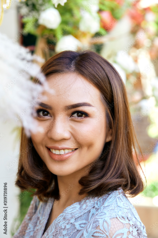 Fototapeta premium Attractive YoungThai woman smiling outdoors