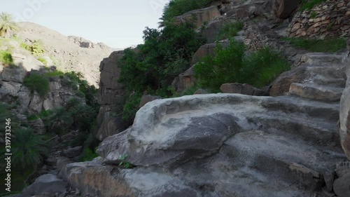 Trekking at Gorge near Old Mountainous Misfat al Abriyeen Village in Oman. First View Perspective photo