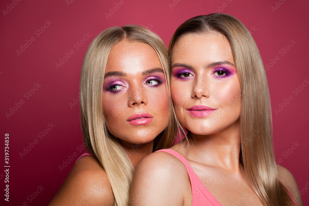 Pretty nice blonde women fashion models with long straight hair and makeup on pink background Pretty nice blonde women fashion models with long straight hair and makeup on pink background