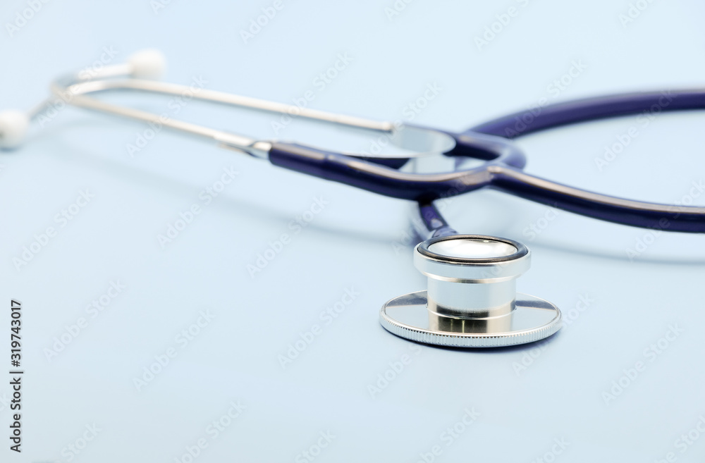 Close up on chest piece of stethoscope for doctor checkup on light blue background with copy space, healthcare and medical concept. Close up on chest piece of stethoscope for doctor checkup on light blue background with copy space, healthcare and medical concept.