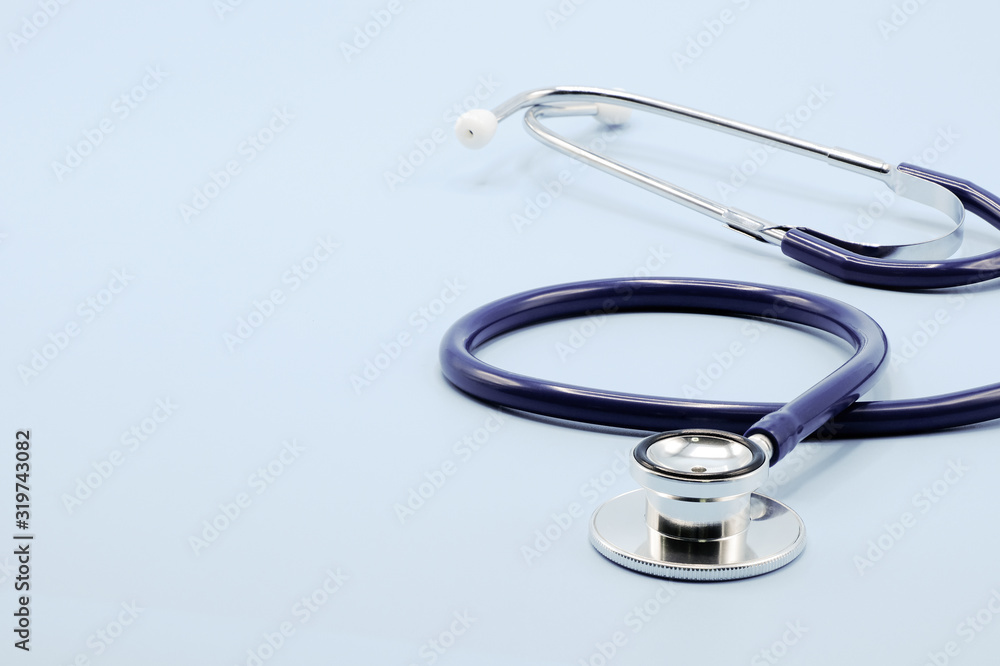 Close up on chest piece of stethoscope for doctor checkup on light blue background with copy space, healthcare and medical concept. Close up on chest piece of stethoscope for doctor checkup on light blue background with copy space, healthcare and medical concept.