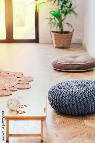 Botanical relaxing living room with grey knitted pouf © allasimacheva
