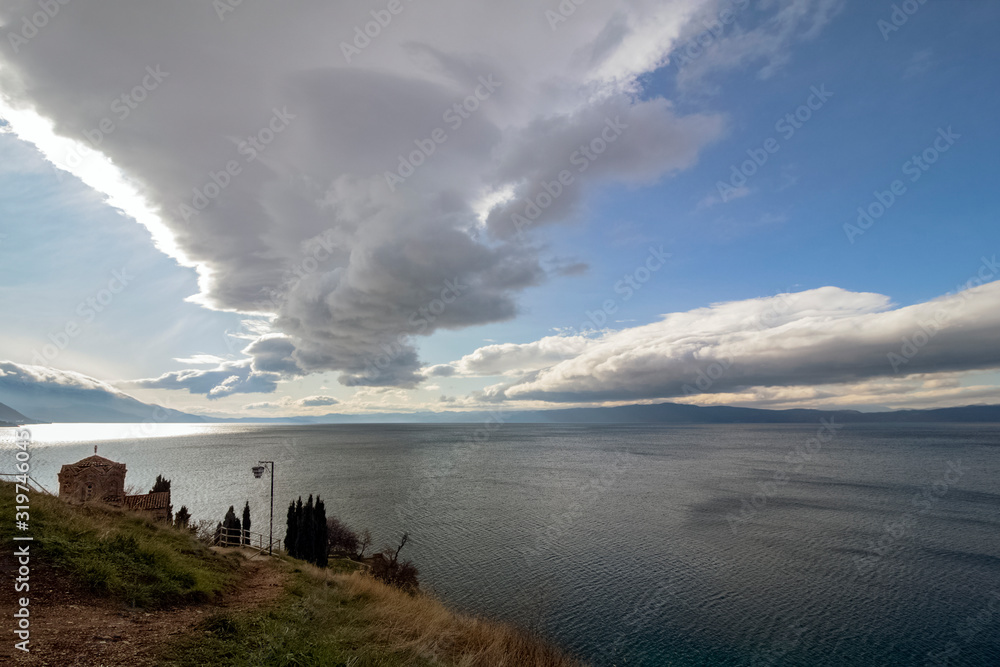 Attractive cloudy scenery over Lake Ohrid with part of the emblematic from This old town San. Kaneo Church. View from above. Northern Macedonia. Attractive cloudy scenery over Lake Ohrid with part of the emblematic from This old town San. Kaneo Church. View from above. Northern Macedonia.