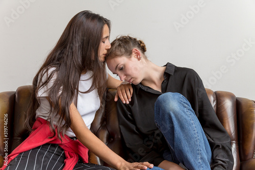 Two Teary Young Women Comforting Each Other