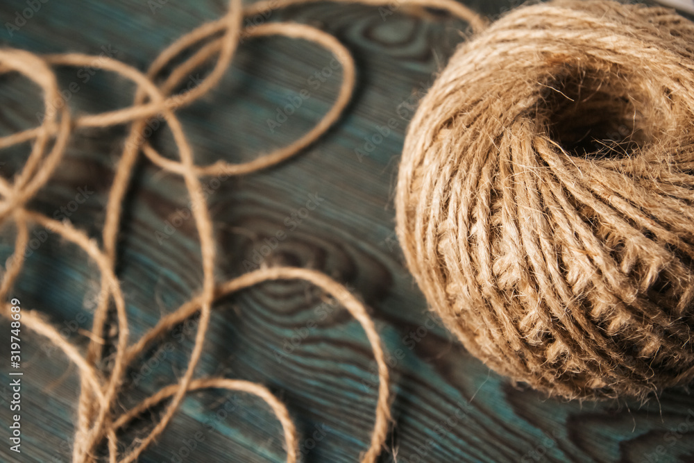 Reel of jute twine on a blue wooden background. Reel of jute twine on a blue wooden background.