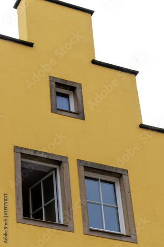 windows on square shaped yellow building 
