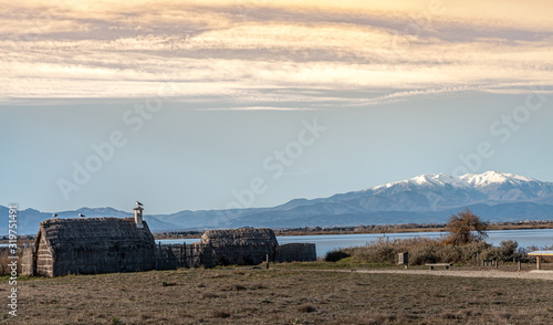 Historic fishing village and the Etang de Canet lagoon and Canigou in the background